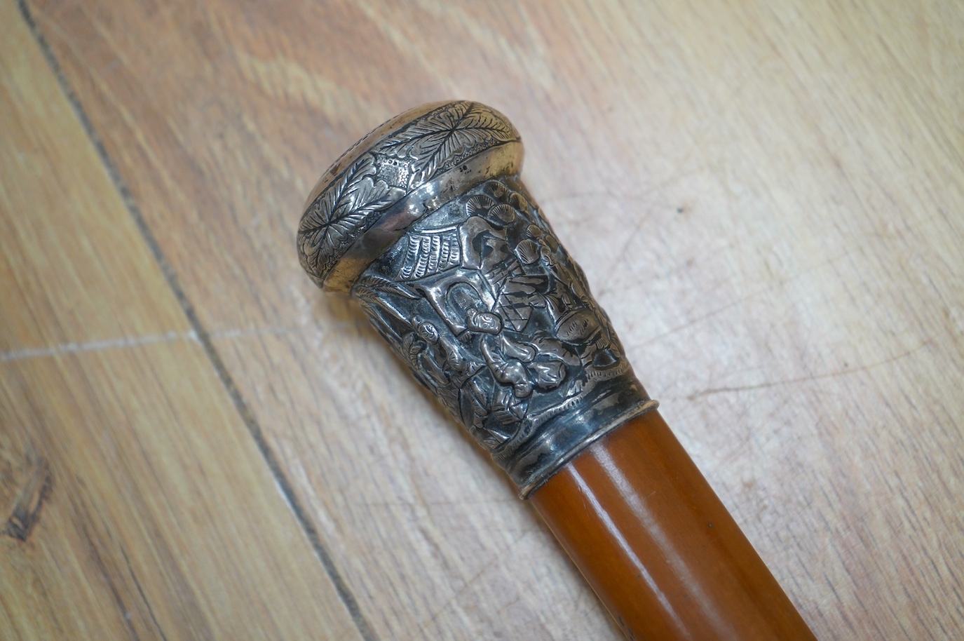 A 19th century Malacca walking cane with a Chinese white metal mount, 92cm high. Condition - fair to good